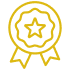Icône d'une médaille dorée avec un bord festonné, une étoile centrale et des rubans, symbolisant un prix, une qualité ou une certification.